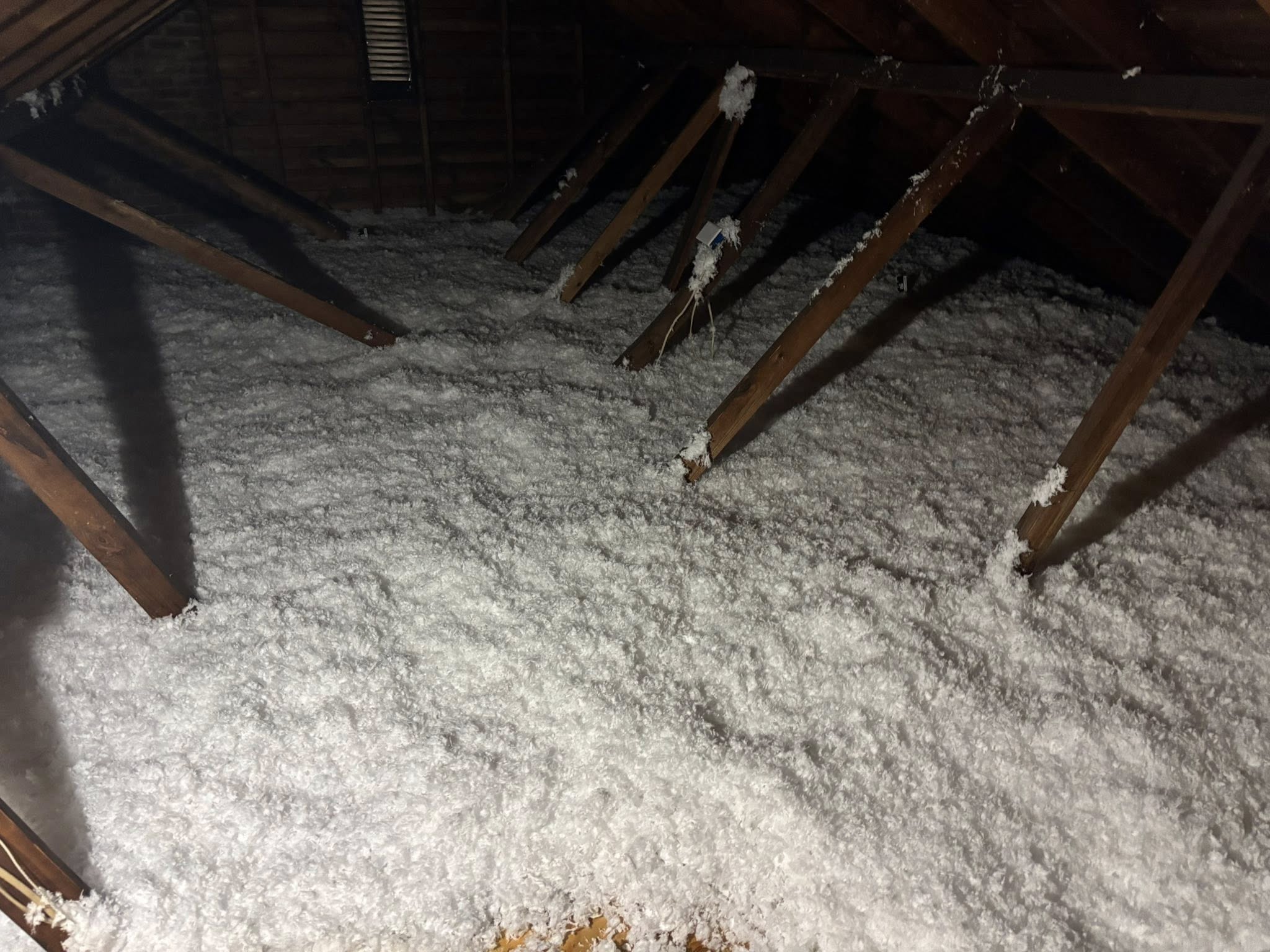 Attic Restoration newly installed blown-in insulation covering attic floor