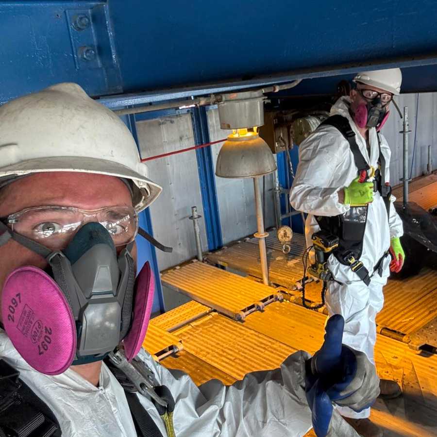 Attic Restoration technicians wearing protective gear and respirators while performing attic cleanup and decontamination work